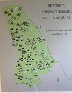 A map with pictures of farmhouses among the lakes and trees